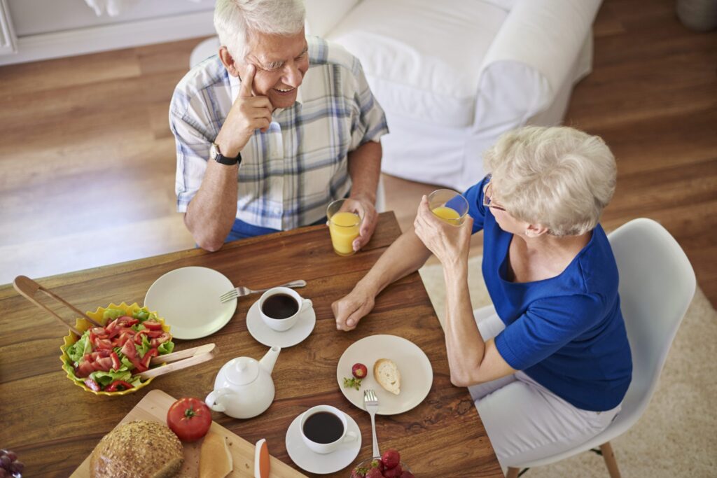 Older adult enjoying a healthy meal at a dining table