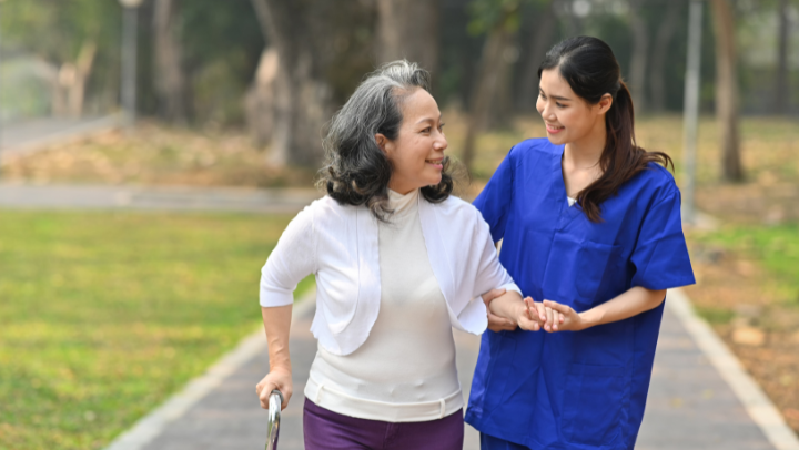 A woman talking with an older woman