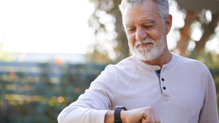 a senior citizen checking his smartwatch