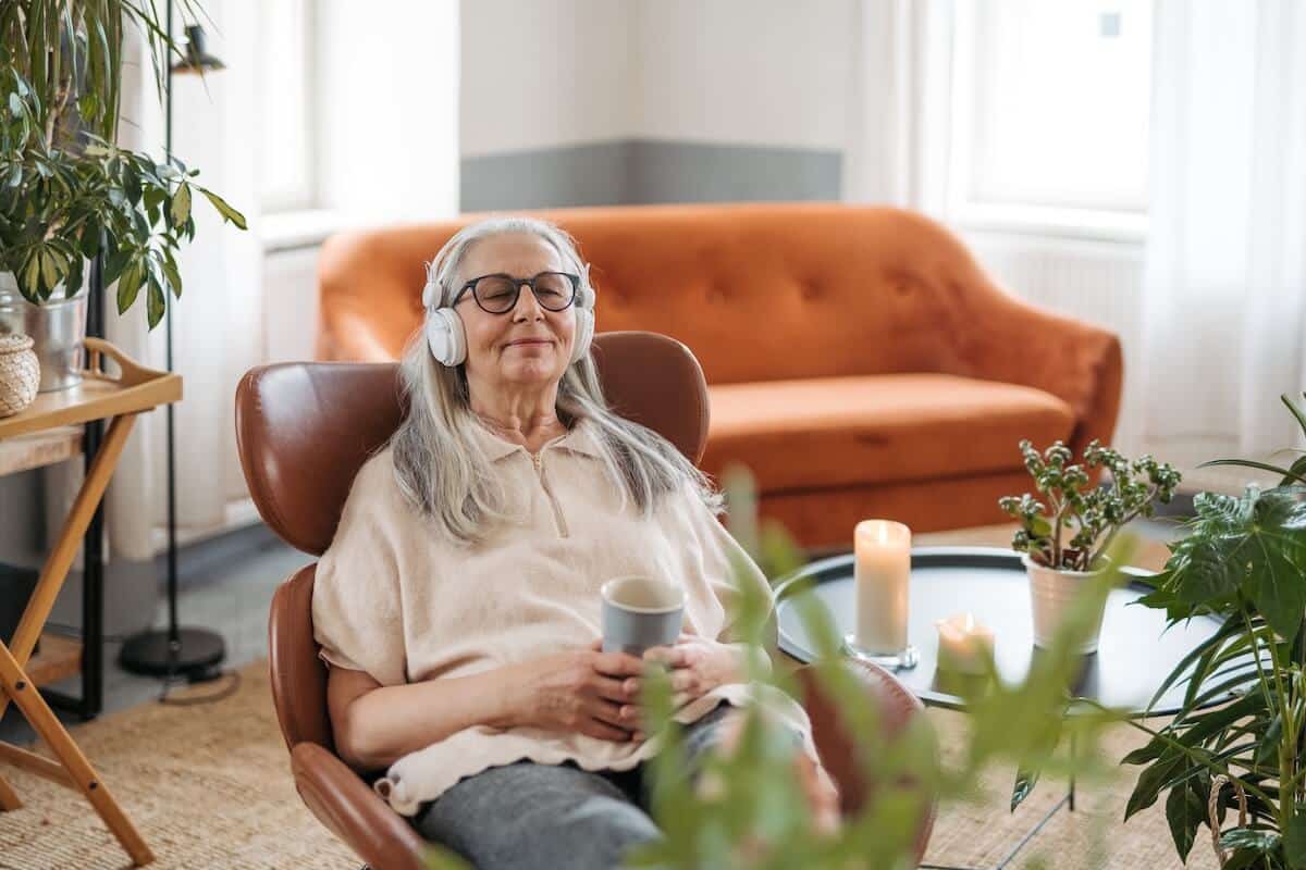 Elderly woman listening music peace of mind
