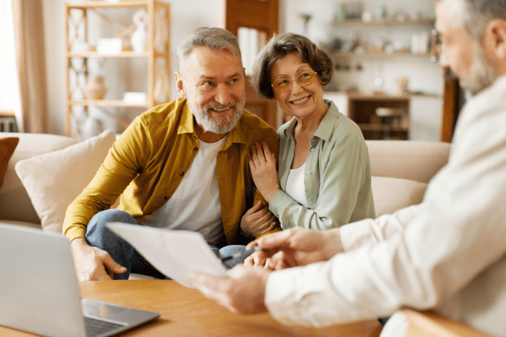 Senior couple talks to senior living professional about finances.